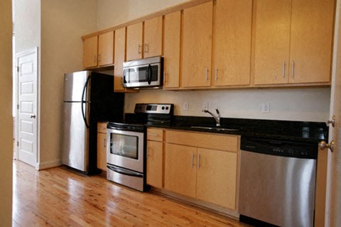 a kitchen with stainless steel appliances and wooden cabinets