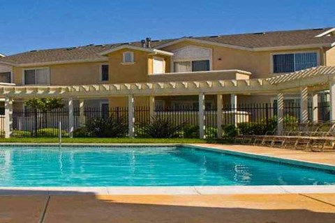 a swimming pool in front of an apartment building
