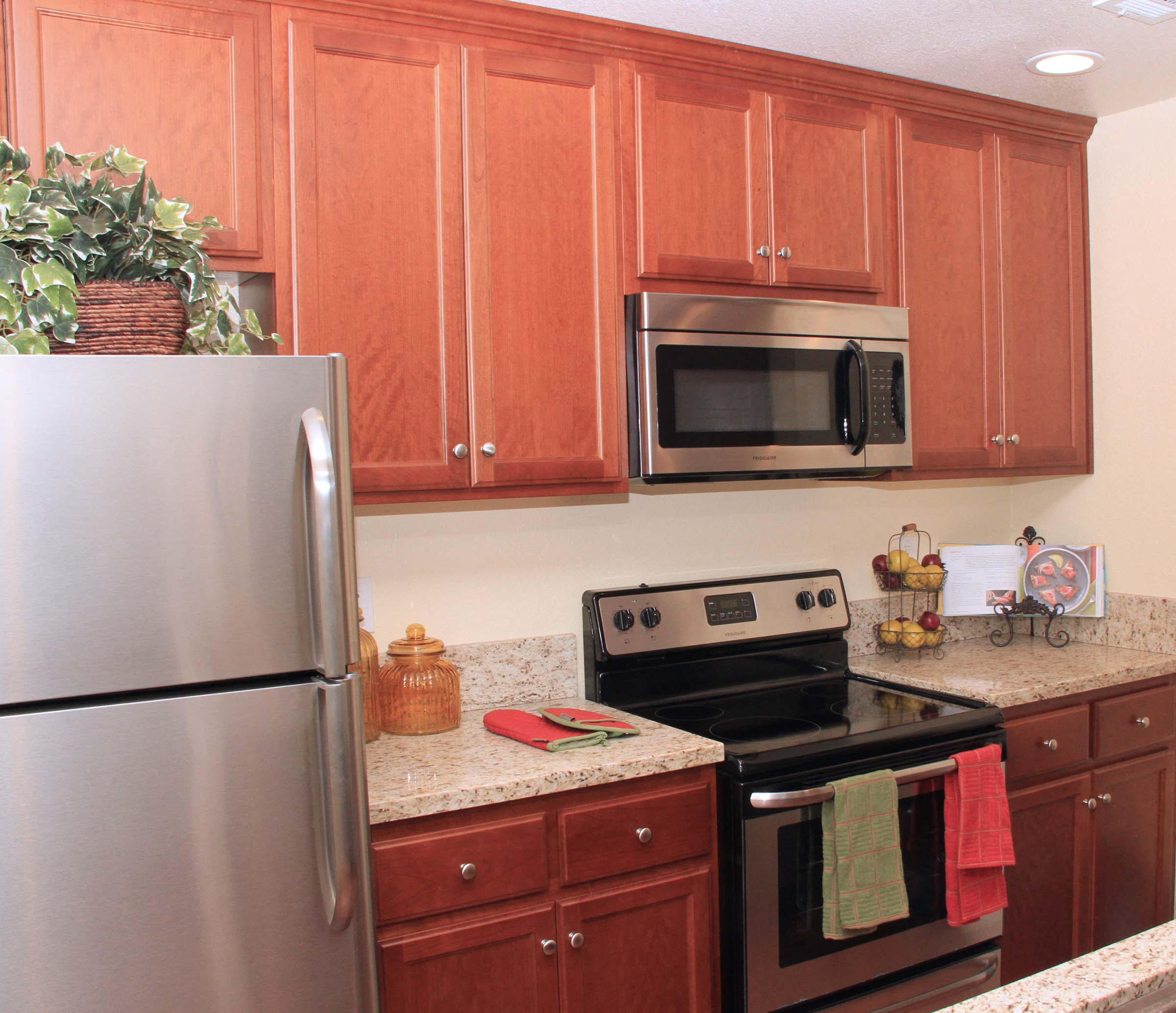 a kitchen with stainless steel appliances and wooden cabinets
