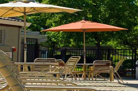 a group of tables and chairs with umbrellas