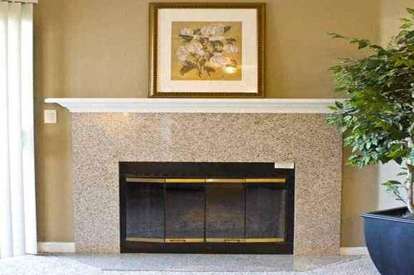 a fireplace in a lobby with a potted plant