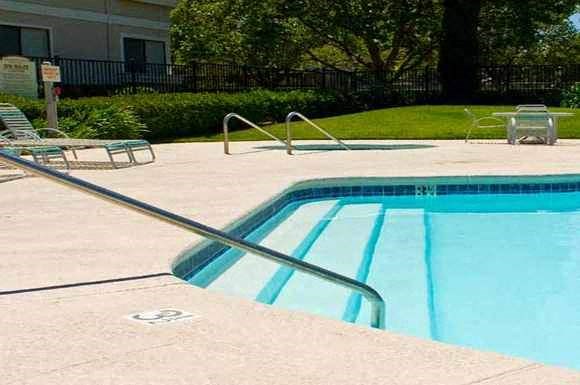 a swimming pool with some chairs in it