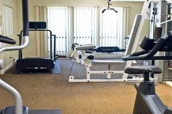 a gym with weights and other equipment in it