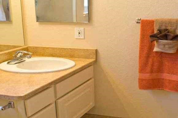 a bathroom with a sink and a mirror and a towel
