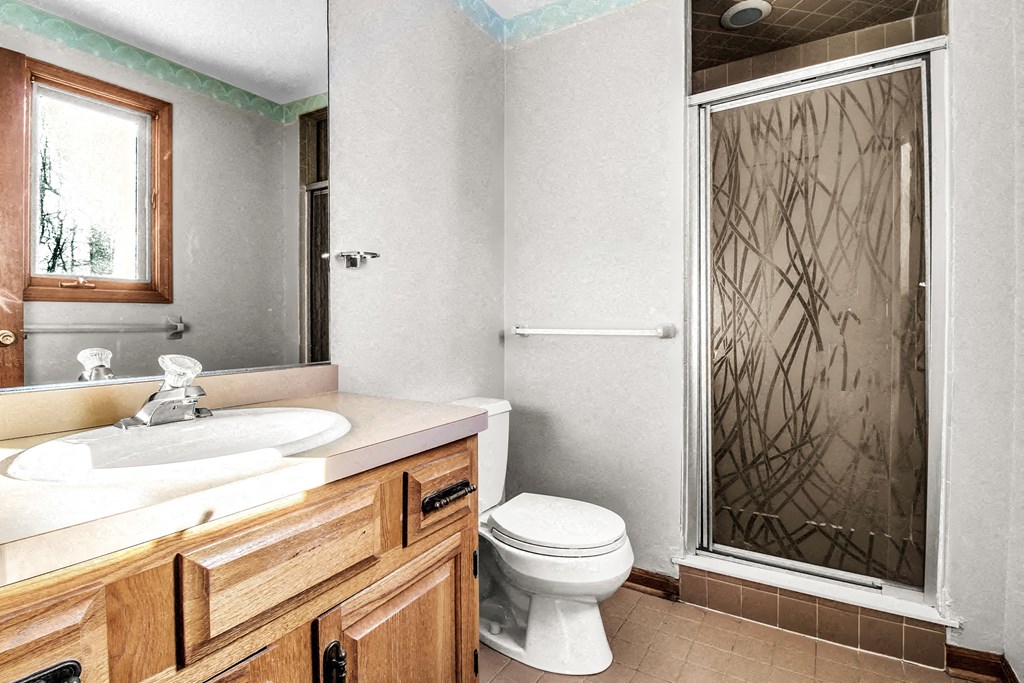 a bathroom with a sink toilet and a shower