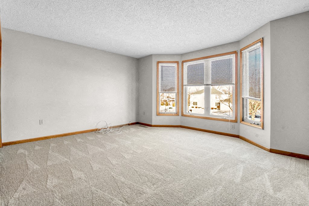 an empty living room with a large window