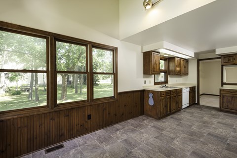 a kitchen with a large window and a sink and a counter