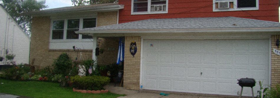 A red house with a white garage door.