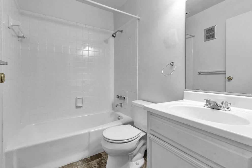 a bathroom with a sink toilet and a bath tub