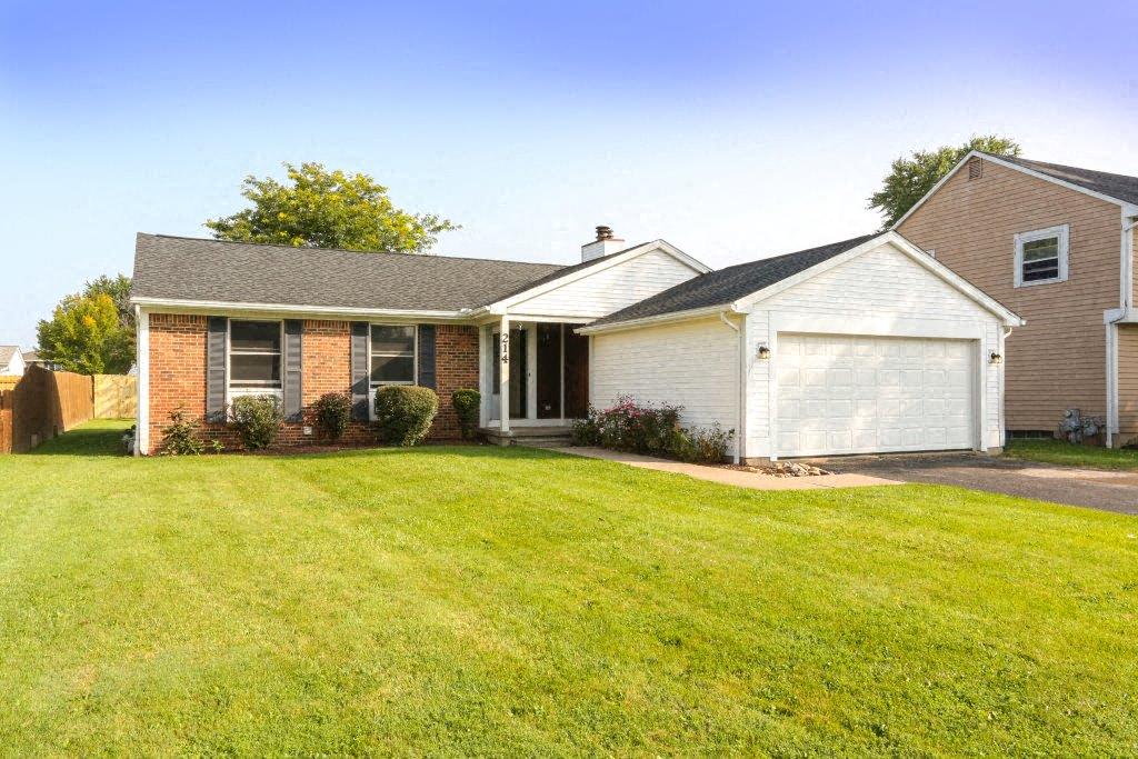 a house with a yard and a white garage door