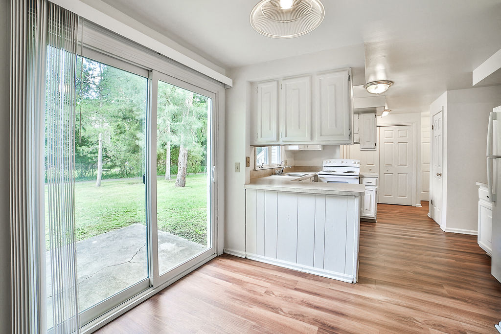 a kitchen with a sliding glass door and a counter top