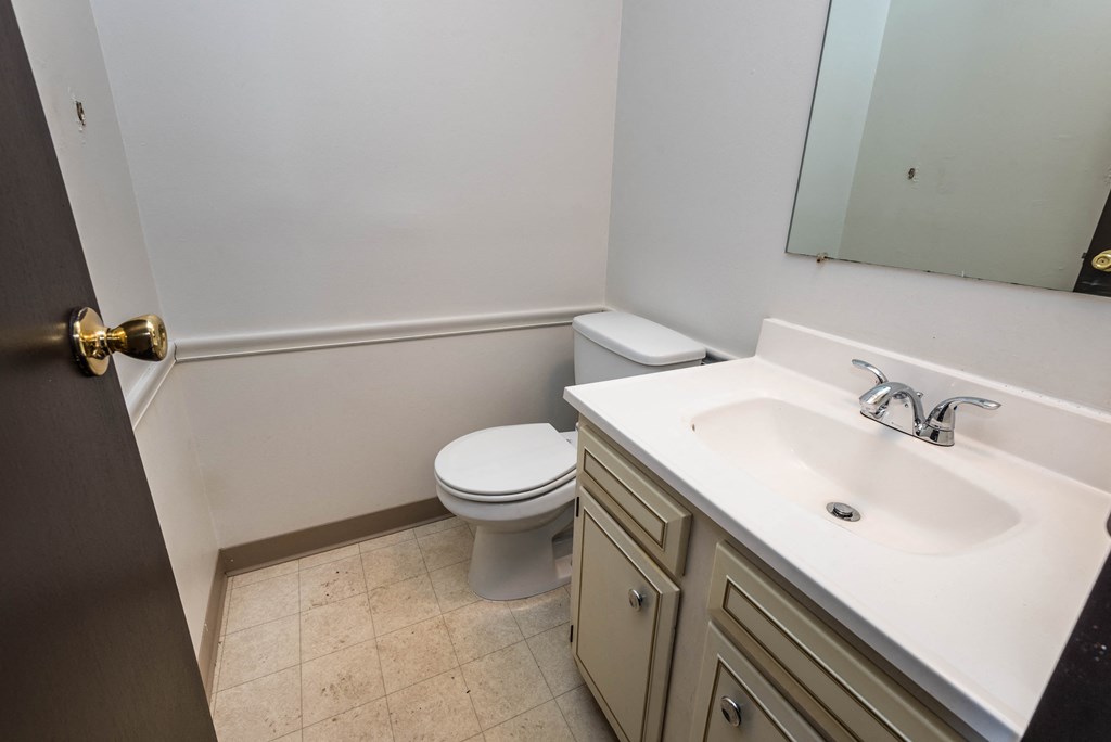 an empty bathroom with a toilet and a sink
