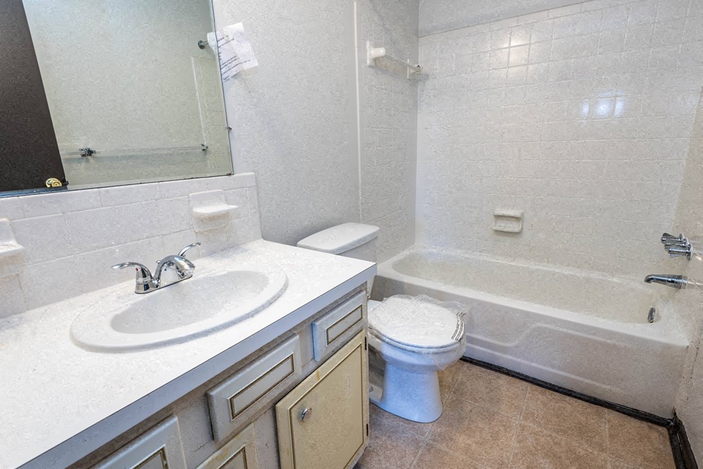 a bathroom with a sink toilet and a bath tub