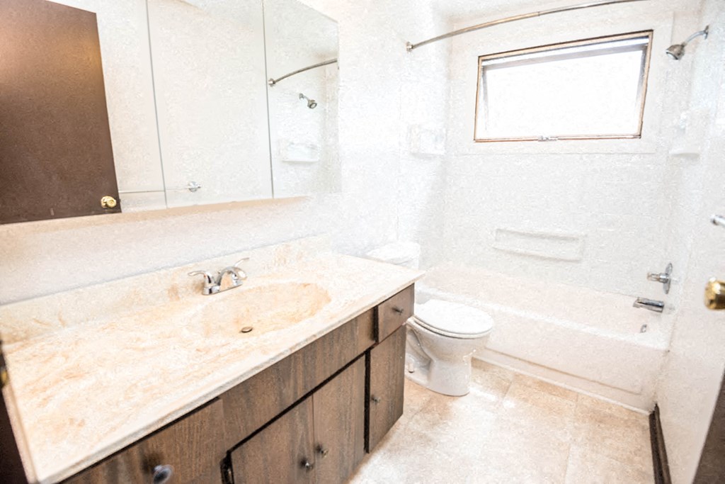 a bathroom with a sink toilet and a bath tub