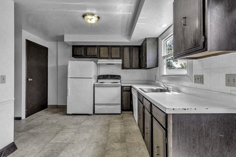a kitchen with white appliances and wooden cabinets
