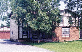 A house with a red brick exterior and a white garage door.