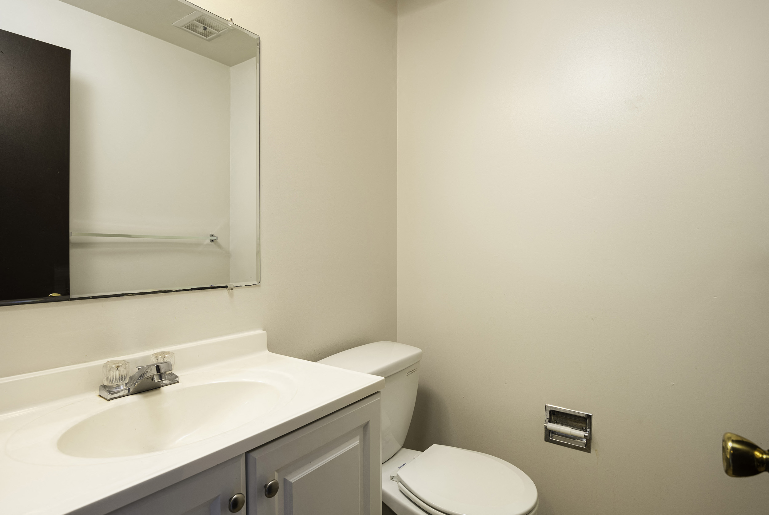 a bathroom with a sink toilet and a mirror