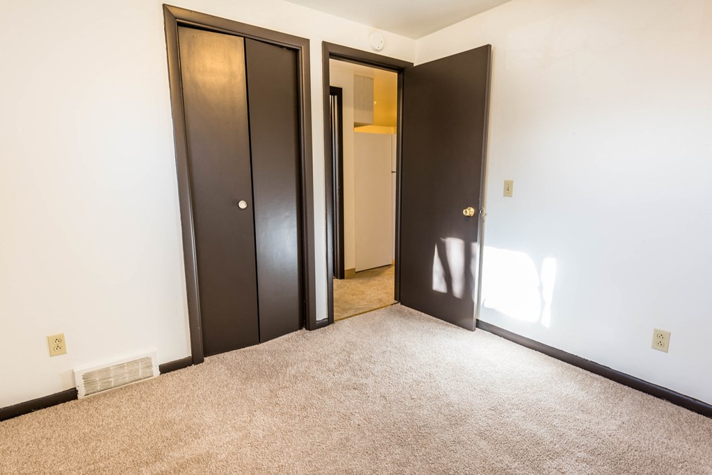 a room with two doors and a carpeted floor