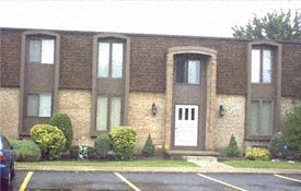 a large brick building with a white door and windows