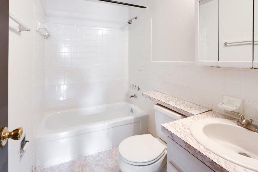 a bathroom with a sink toilet and a bath tub