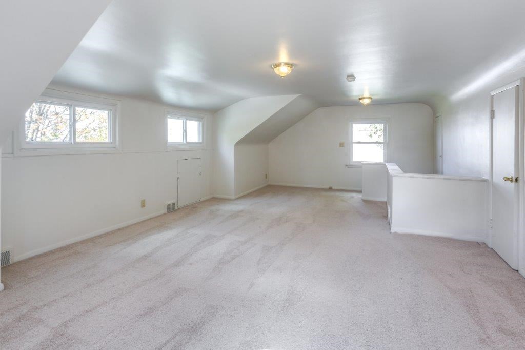 an empty living room with white walls and a white floor