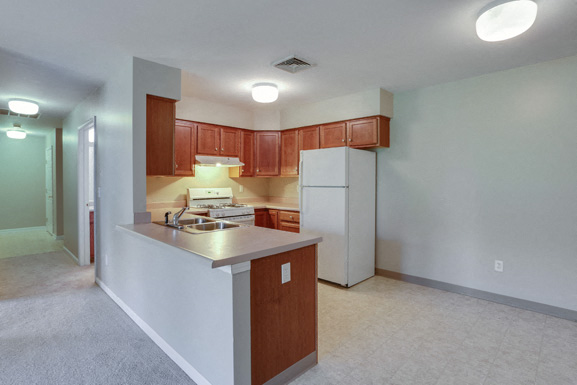 a kitchen with a white refrigerator and a counter top