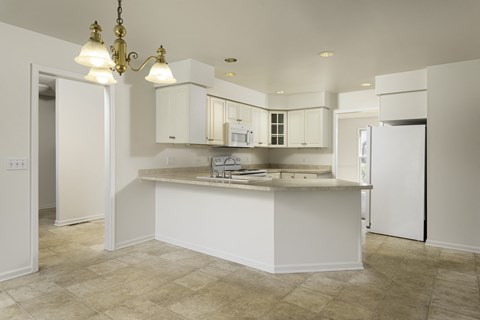 A kitchen with white cabinets and a countertop.