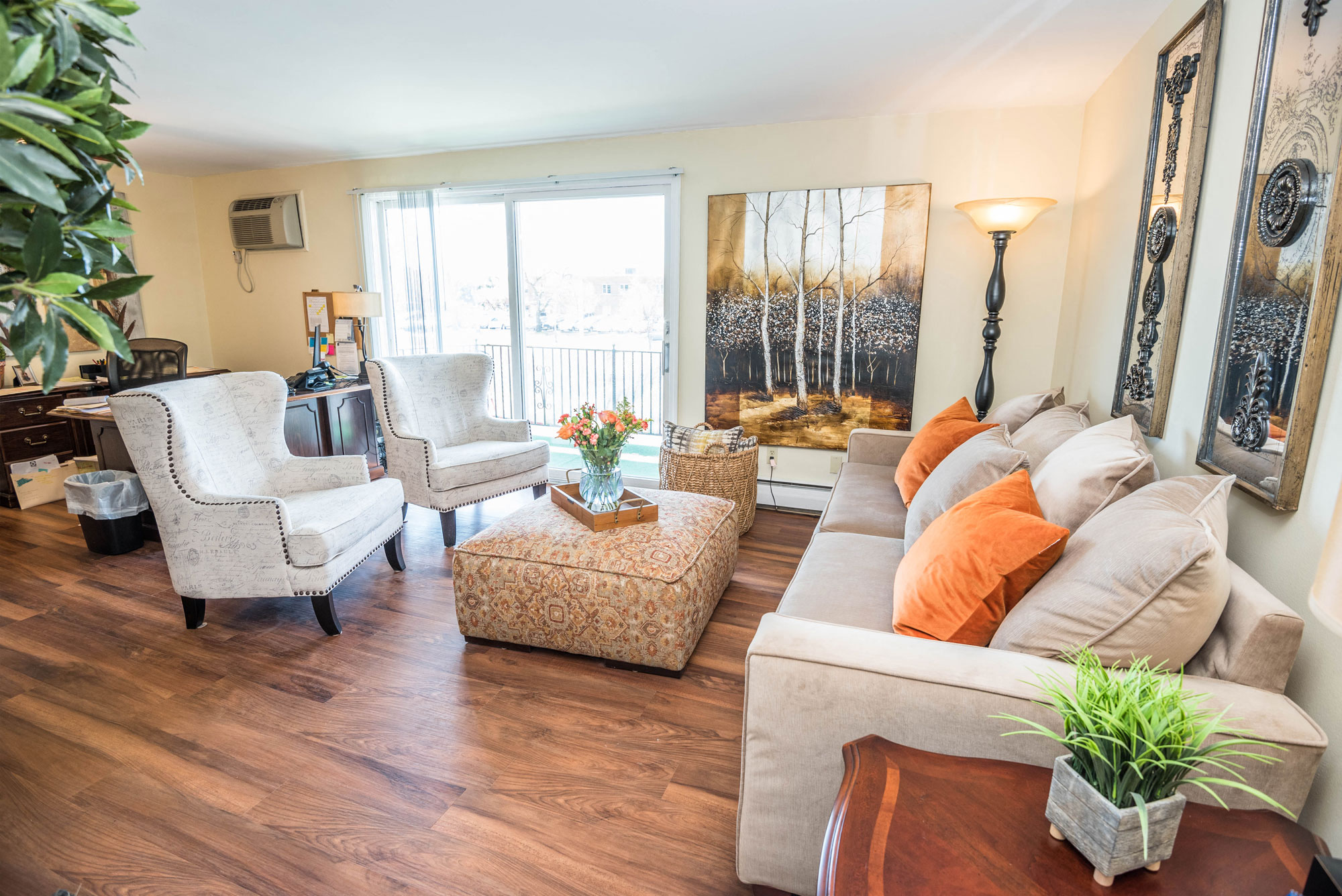 a living room with a couch and chairs and a table