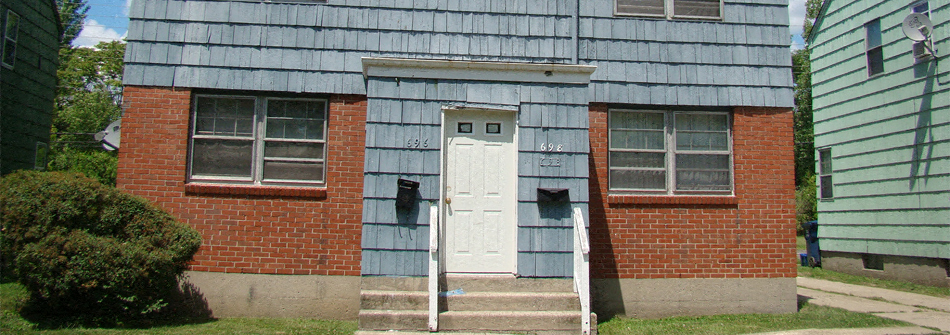 an old red brick house with a white door