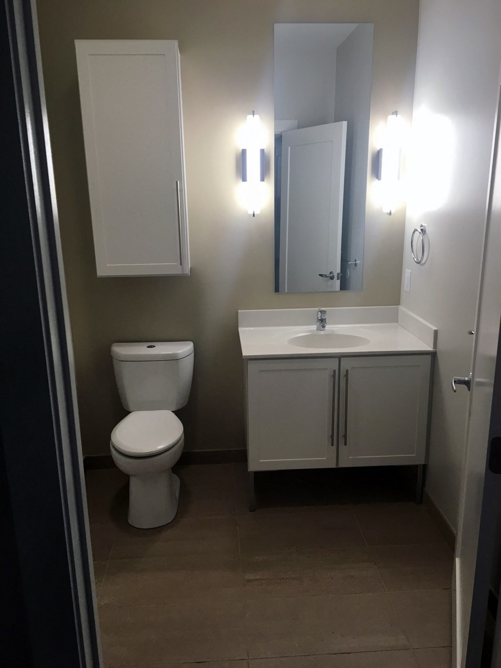 a small bathroom with a toilet sink and mirror