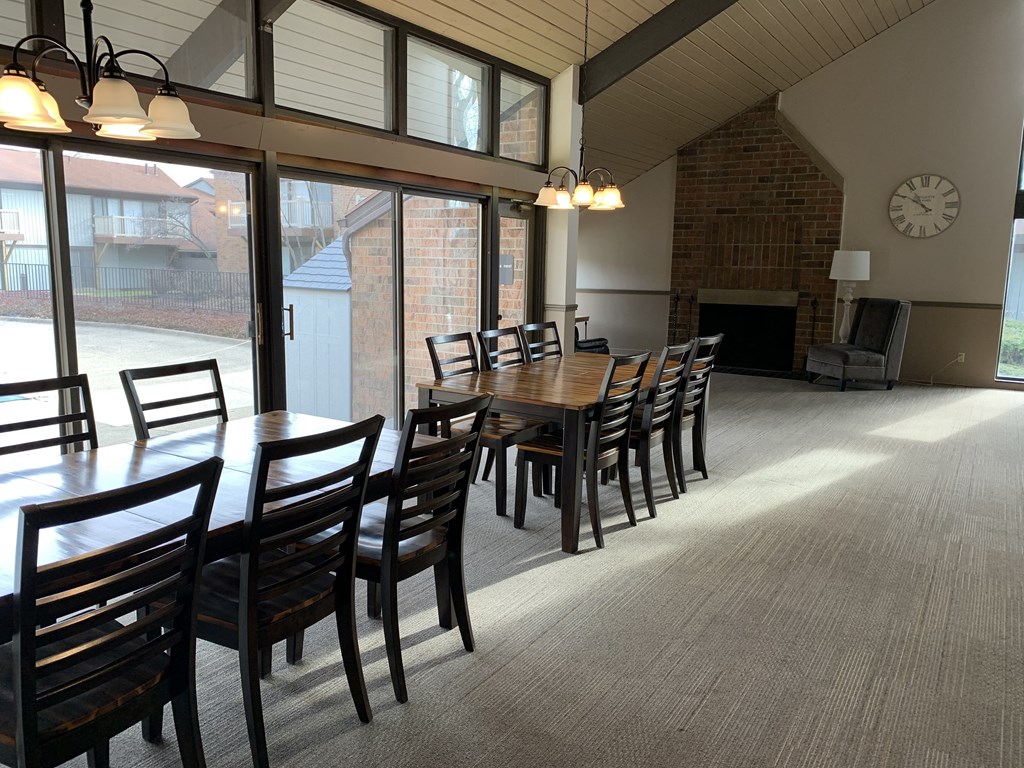a dining room with a long wooden table and chairs