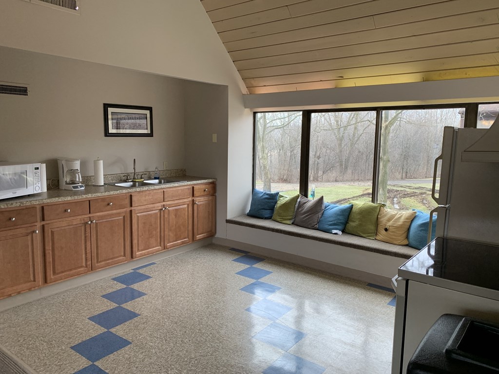 a kitchen with a large window and a sink and a counter