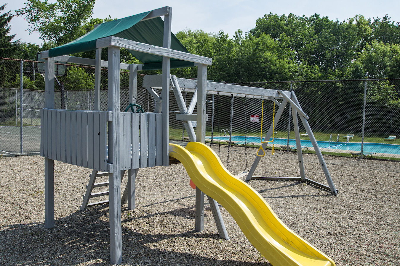 a playground with a slide and a swing set