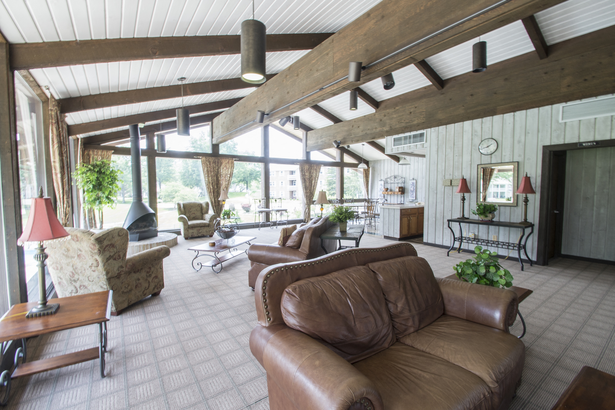 a living room with leather furniture and large windows