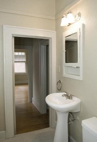 a white bathroom with a sink and a mirror