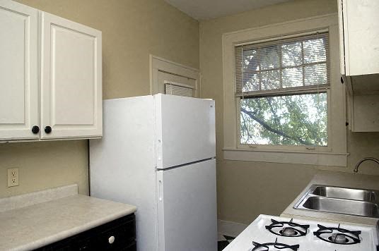 a small kitchen with a stove and a refrigerator