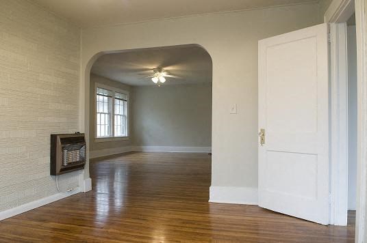 an empty living room with a fireplace and a white door
