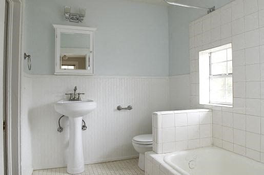 a white bathroom with a sink and a toilet