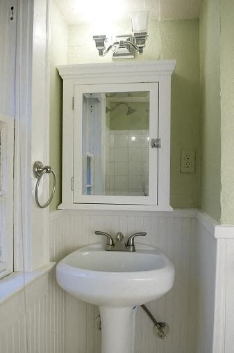 a bathroom with a white sink and a mirror