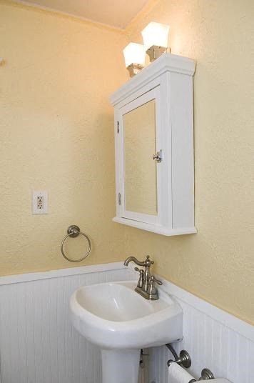 a bathroom with a white sink and a mirror