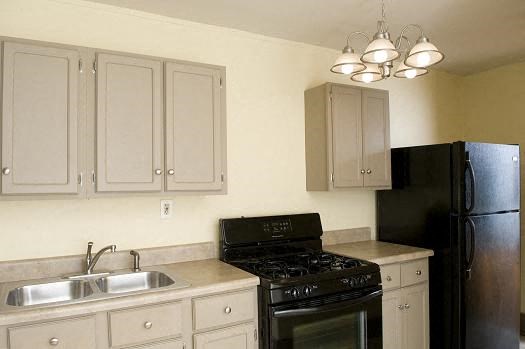 a kitchen with a stove and a refrigerator and a sink