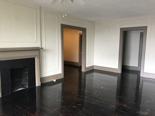 a empty room with a fireplace and a door
