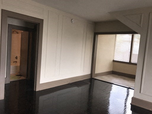 an empty room with white walls and a window