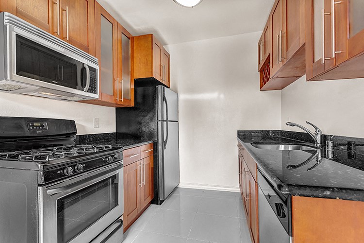 a kitchen with stainless steel appliances and wooden cabinets