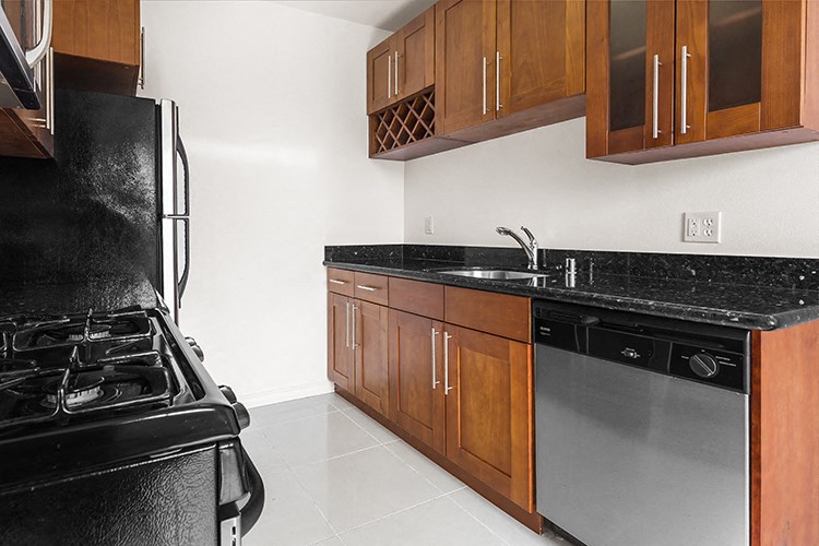 a kitchen with a stove and a sink and a refrigerator