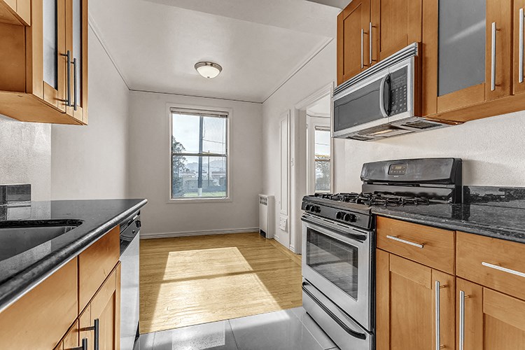 a kitchen with stainless steel appliances and wooden cabinets