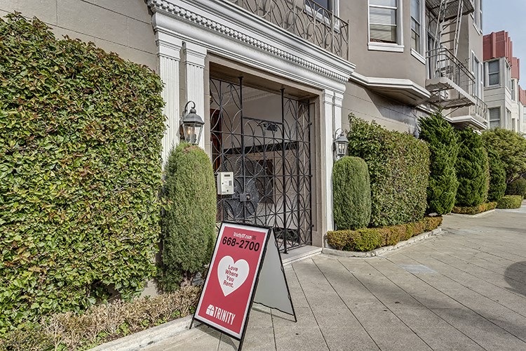 a sign in front of a building with a heart on it