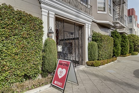 a sign in front of a building with a heart on it