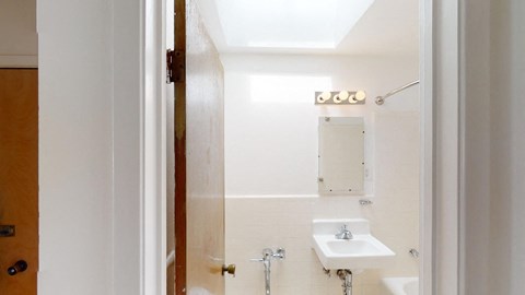 a white bathroom with a sink and a mirror