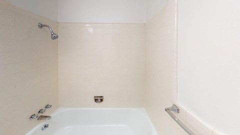 a bathroom with a white tub and a shower